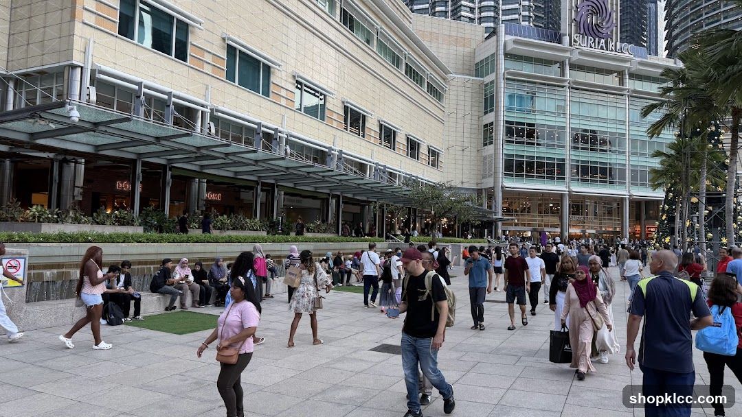 People walking in front of a large shopping mall