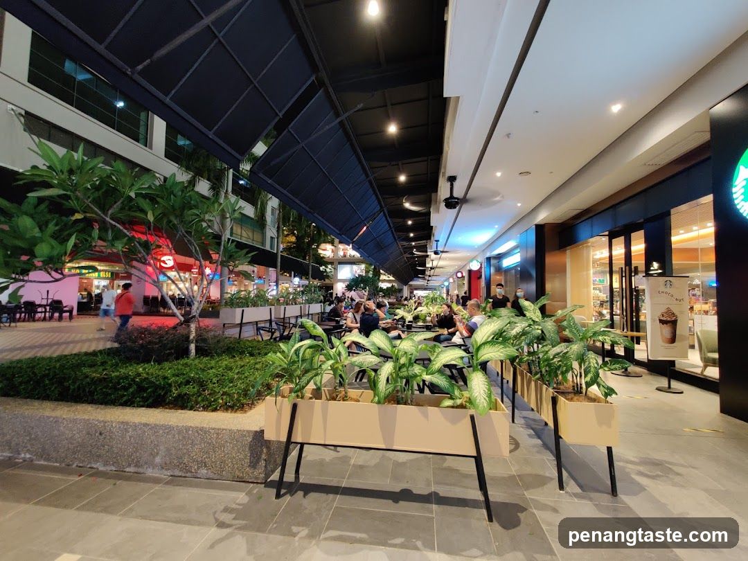 Outdoor seating area with plants and shops