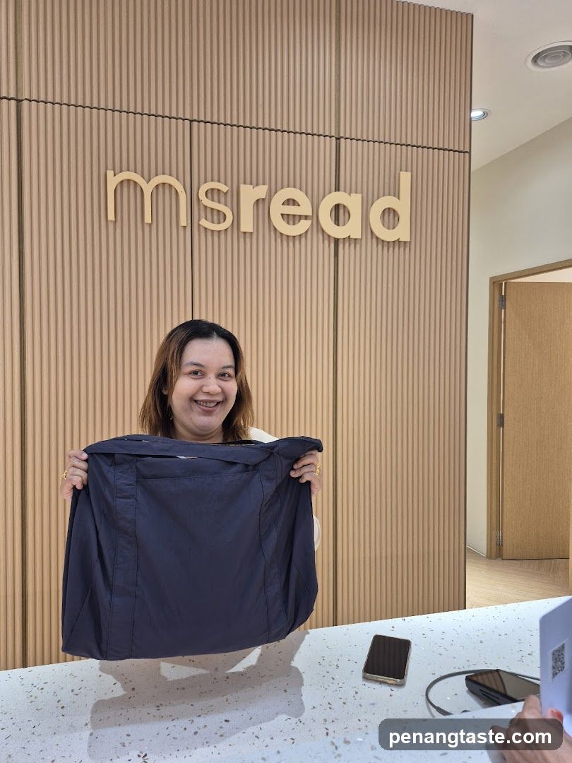 Woman holding a bag in front of a store sign