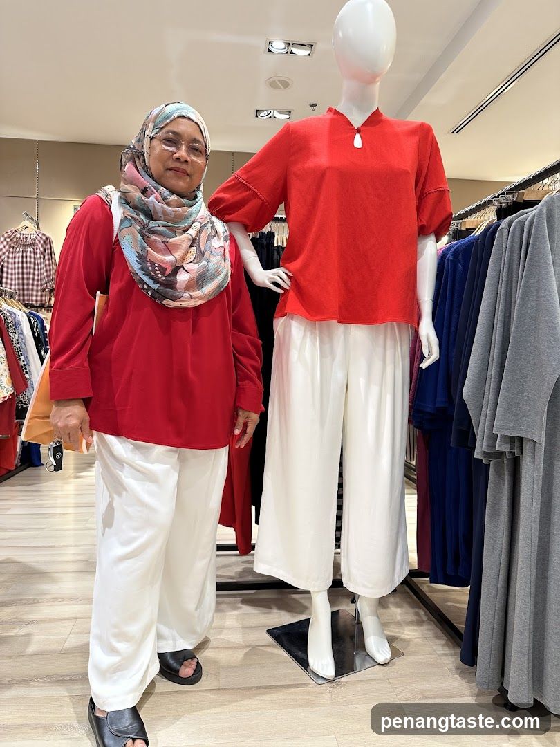 Woman Poses Next to Mannequin in Clothing Store