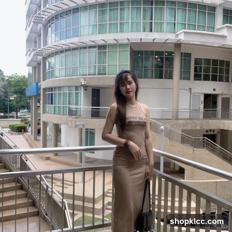 Woman in beige dress standing on balcony