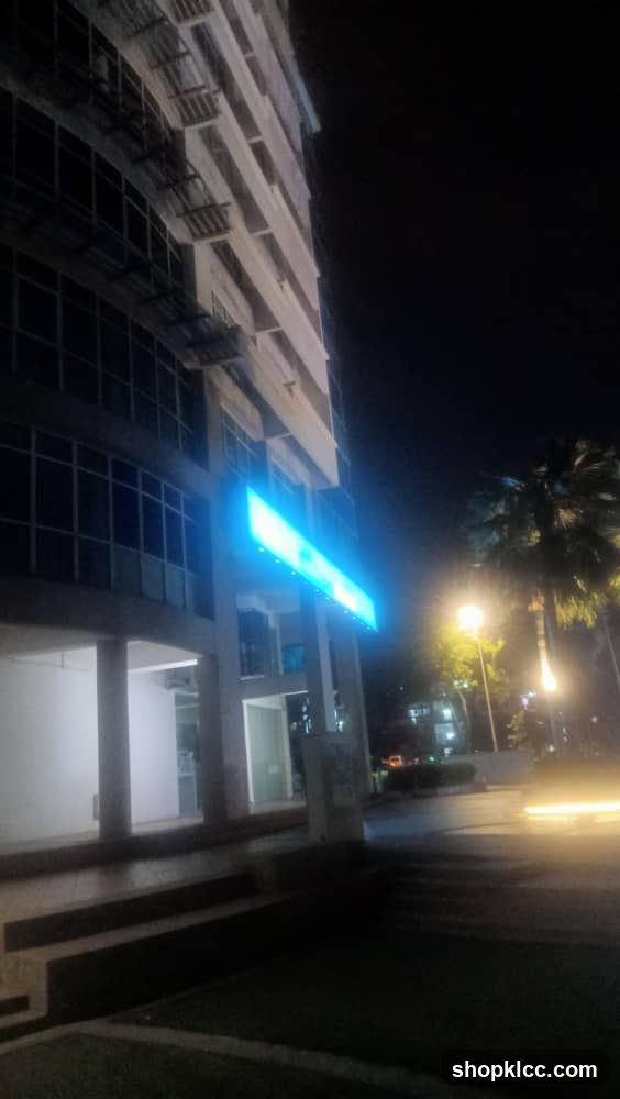 Night view of building exterior with illuminated sign