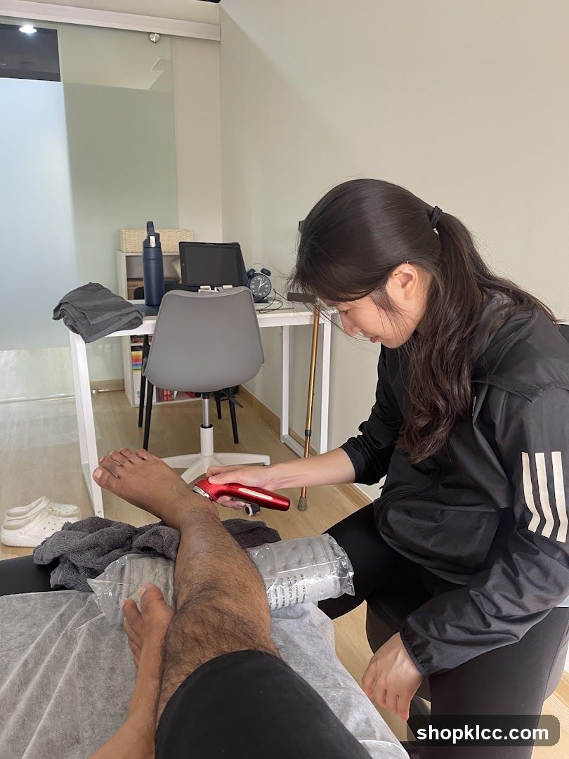 Therapist using a device on a patient's leg