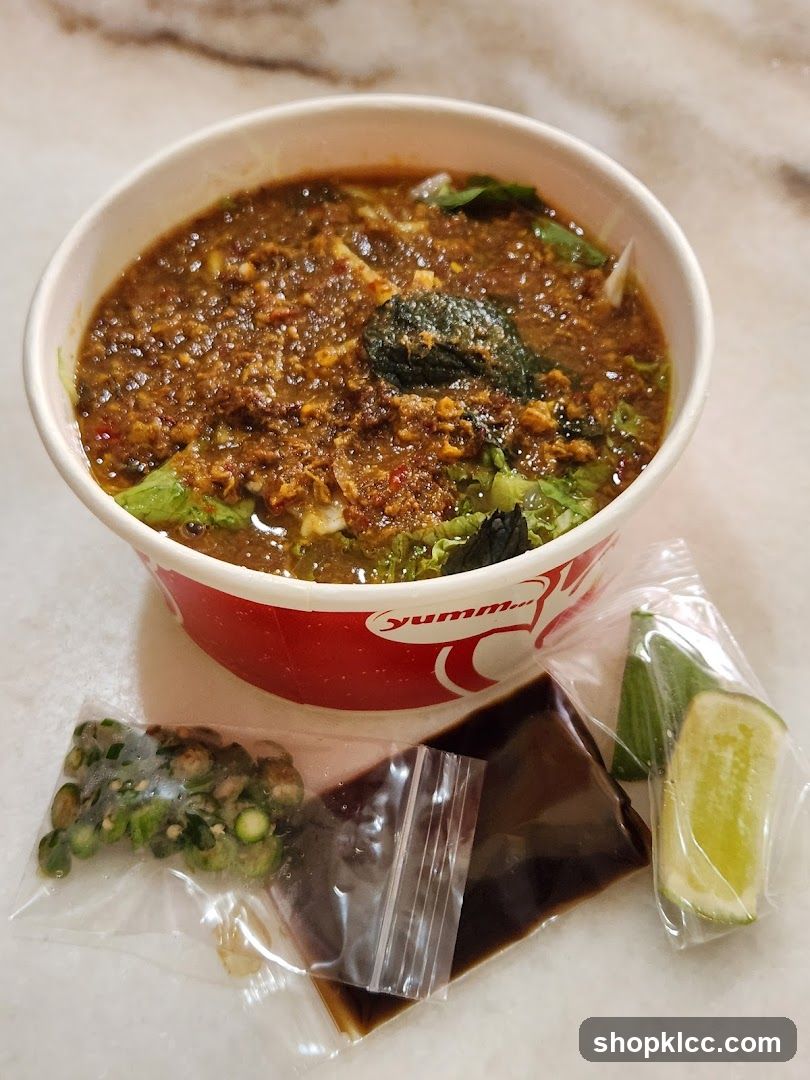 Bowl of Spicy Noodle Soup with Condiments