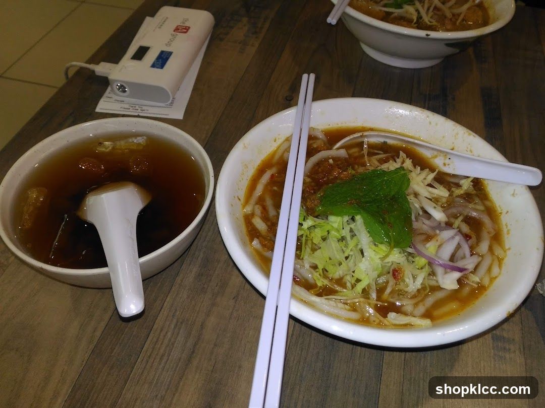 Bowl of noodles with soup and condiments
