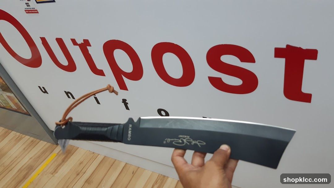 Knife held in front of storefront