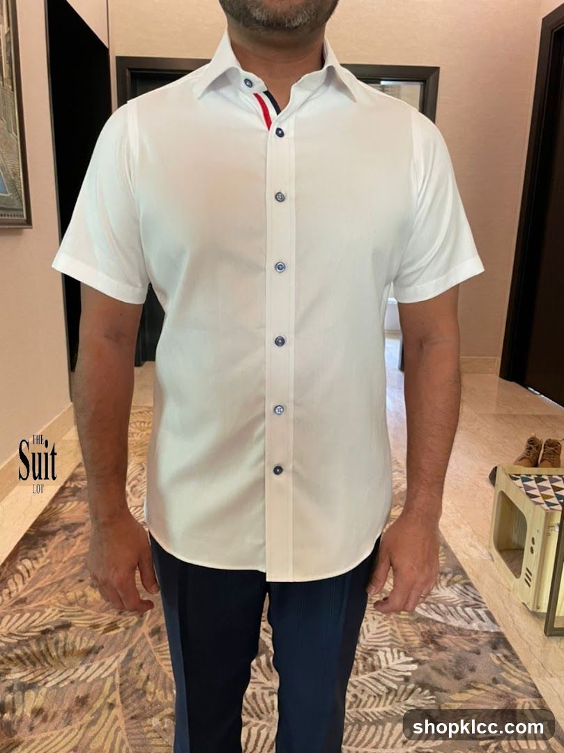 Man wearing white short-sleeve shirt and dark trousers