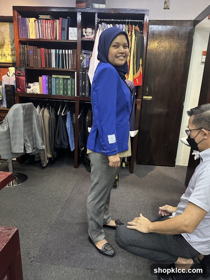 Interior of a clothing store with staff and customer