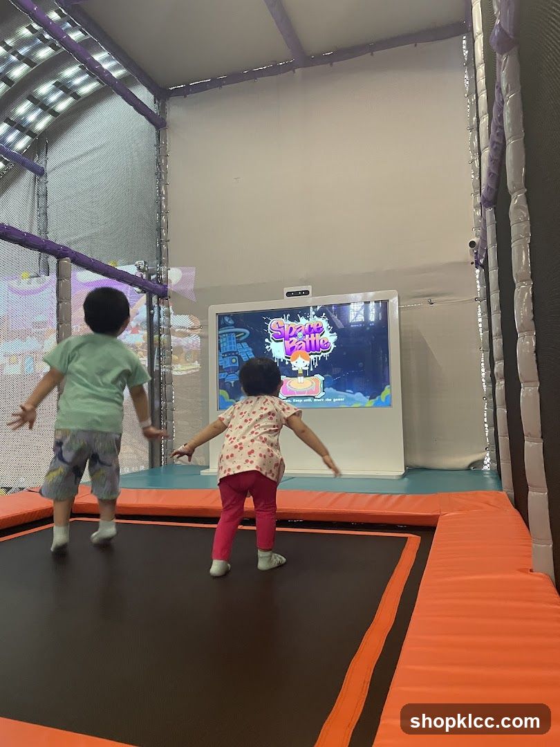 Kids Playing on Trampoline with Screen Game