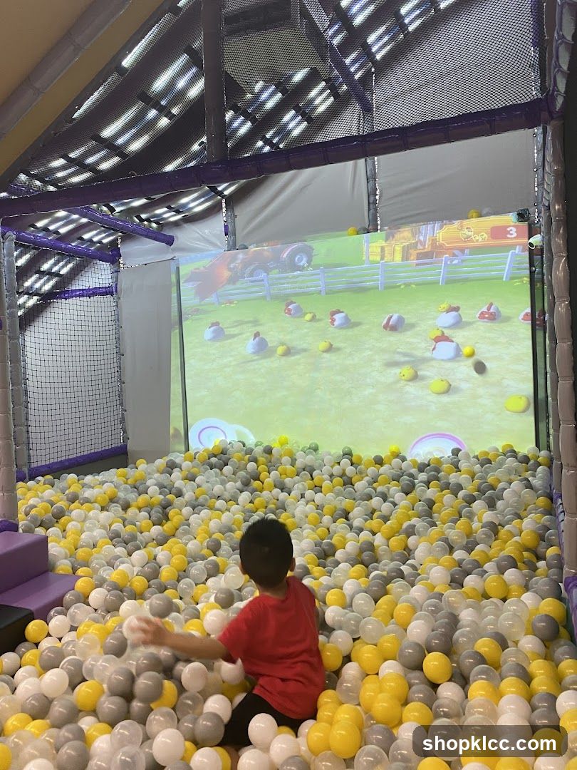 Child in Ball Pit with Screen Game