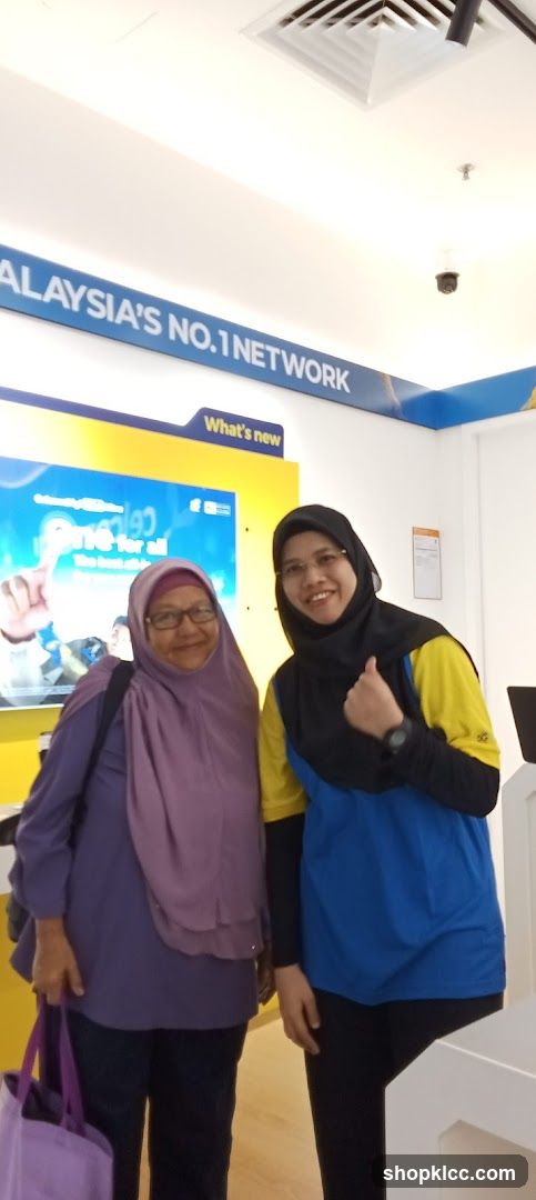 Two women posing in a store
