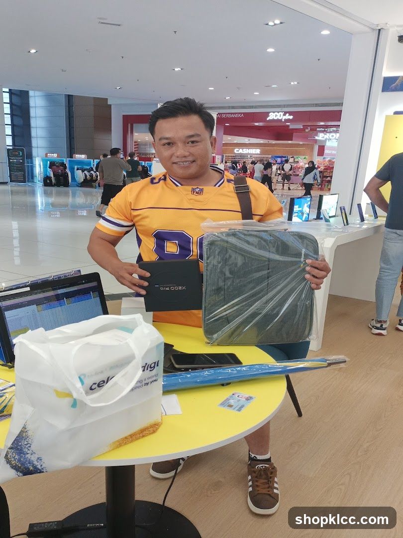 Man Holding Laptop Bag and Box