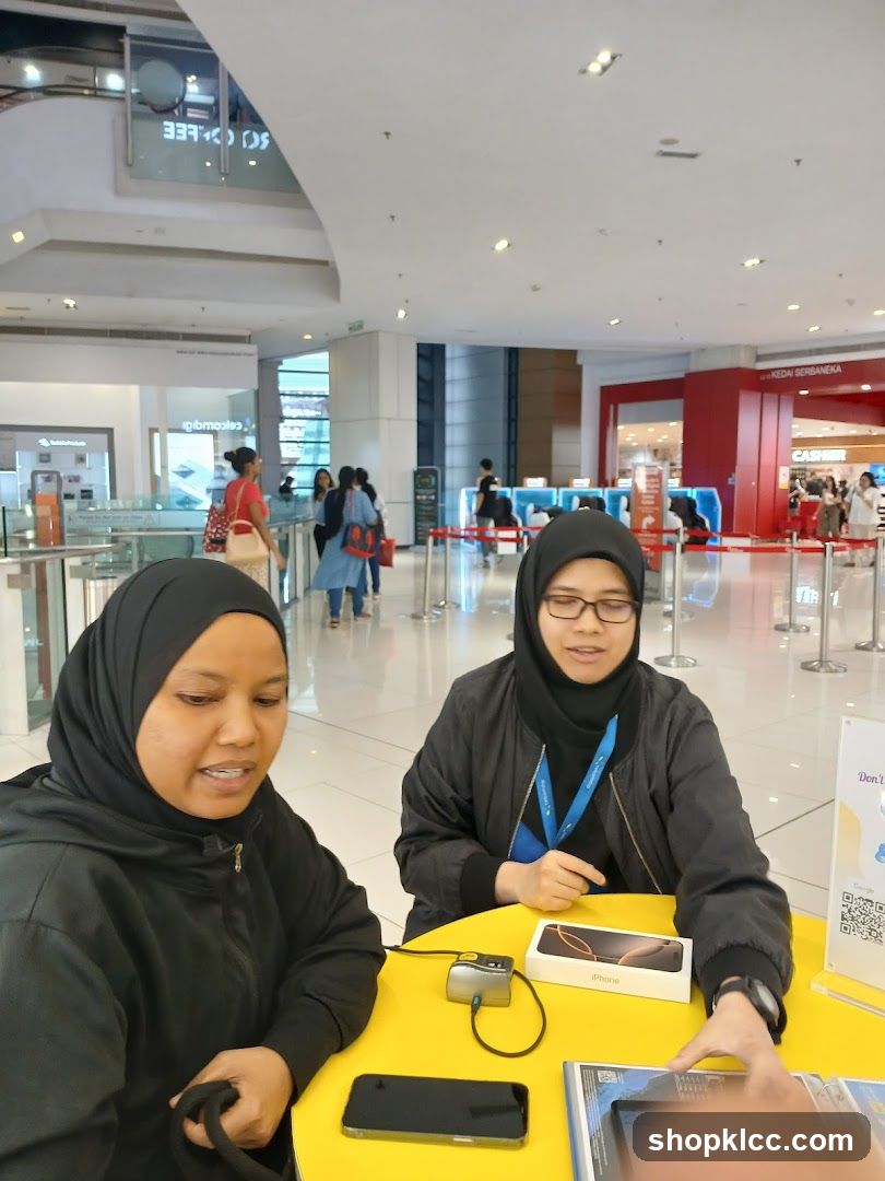 Two women at a table with phones