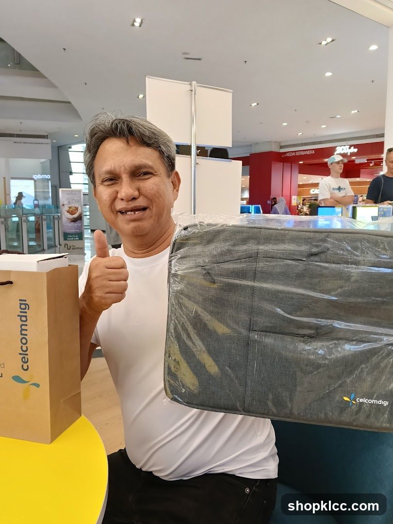 Man with Celcom Diggi Bag and Laptop Sleeve