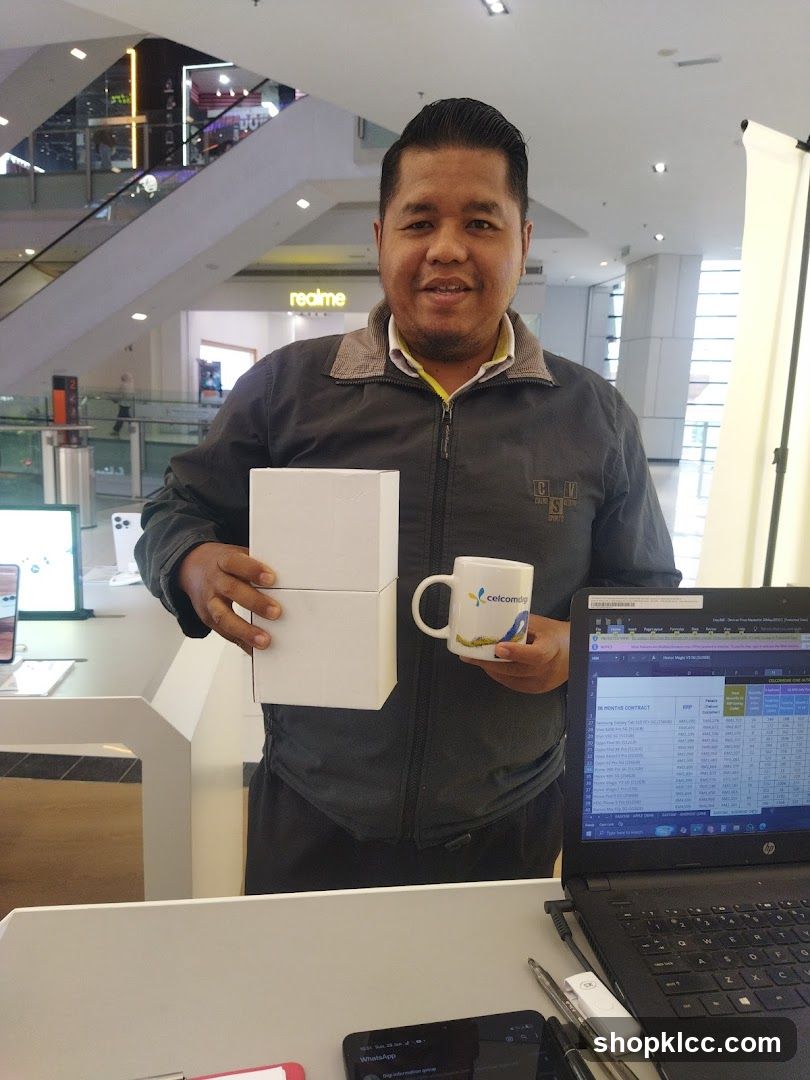 Man holding boxes and mug in a store