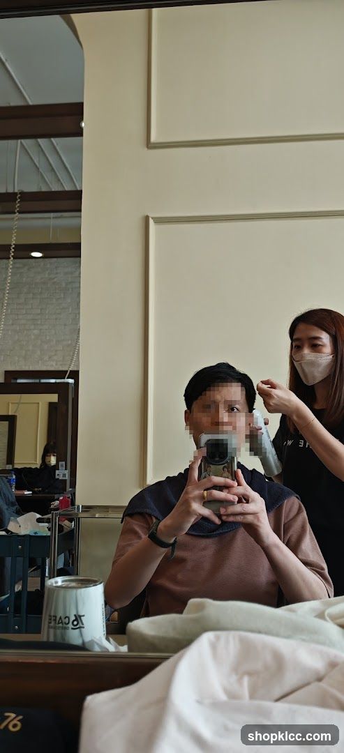 Hairdresser styling client's hair