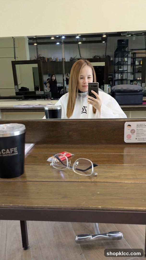 Woman taking a selfie in a salon