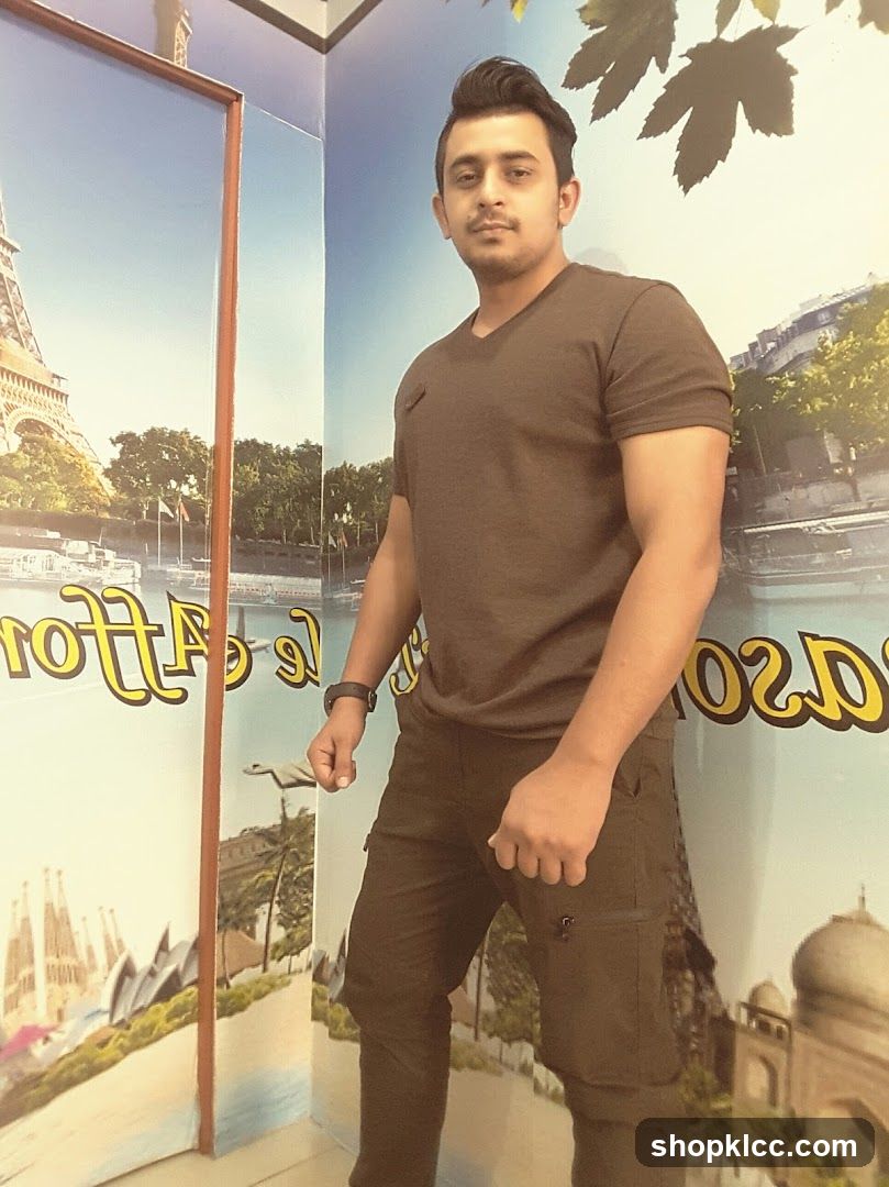 Man posing in front of travel poster display