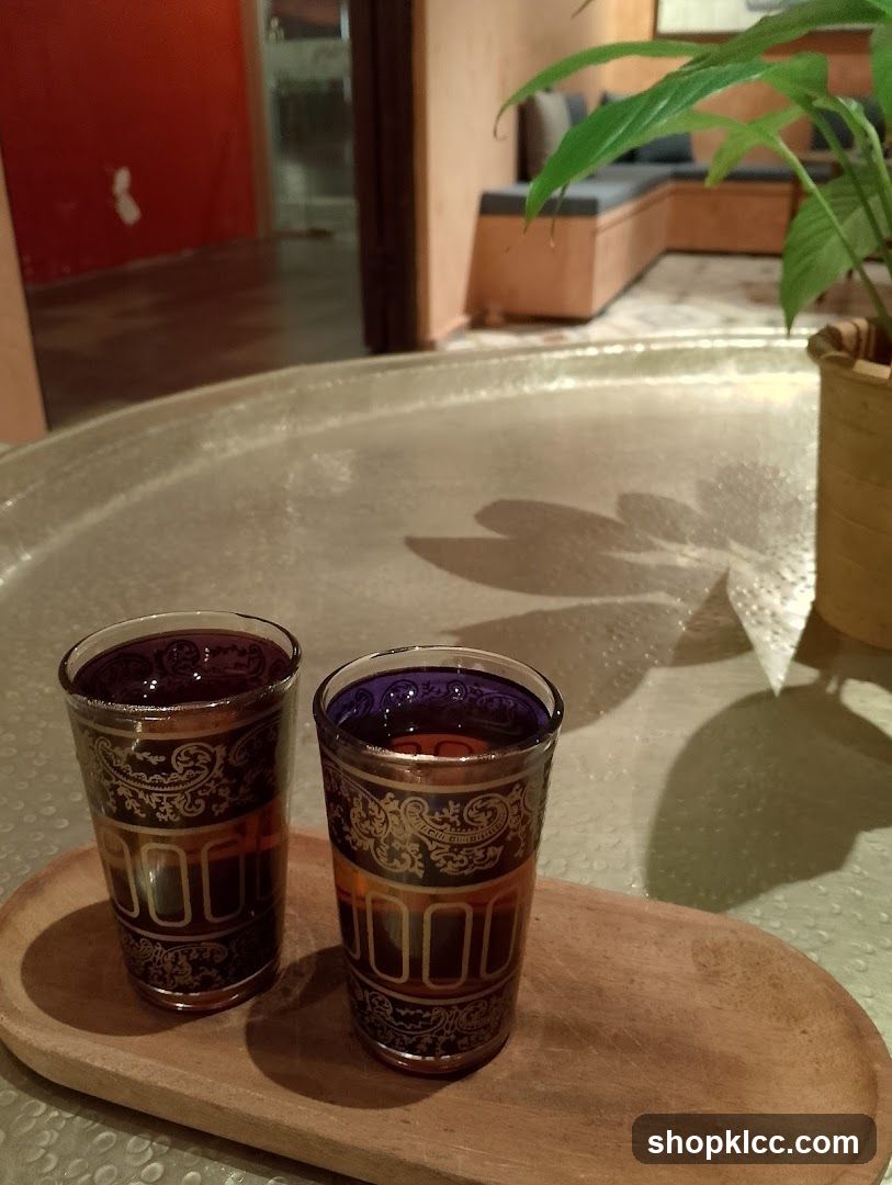 Two glasses of dark liquid on a tray