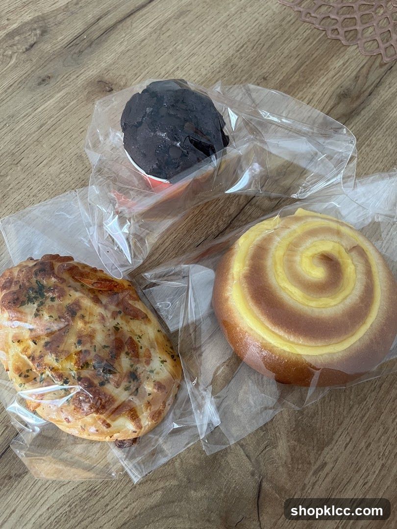 Three baked goods on a wooden surface