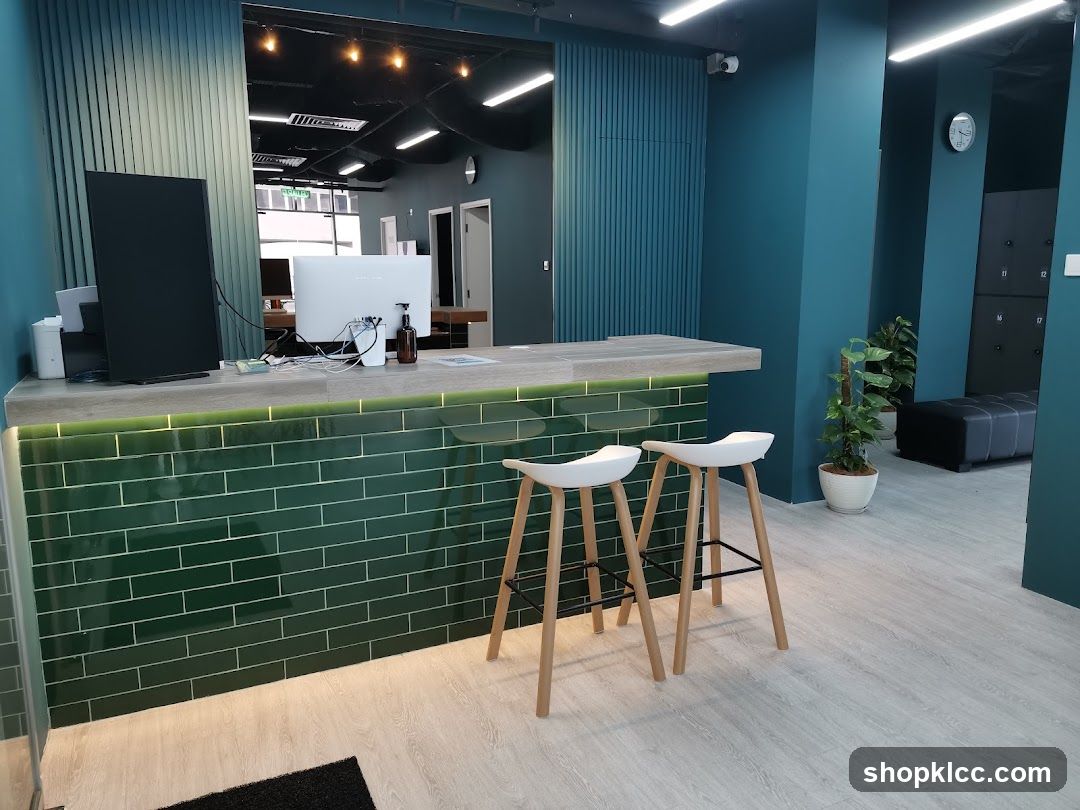 Modern reception area with green tiled counter and bar stools