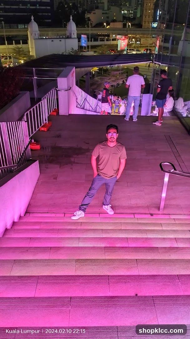 Man posing on illuminated stairs at night