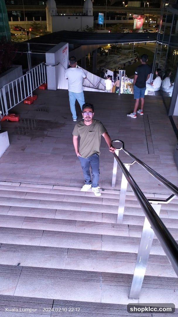 Man posing on stairs at night