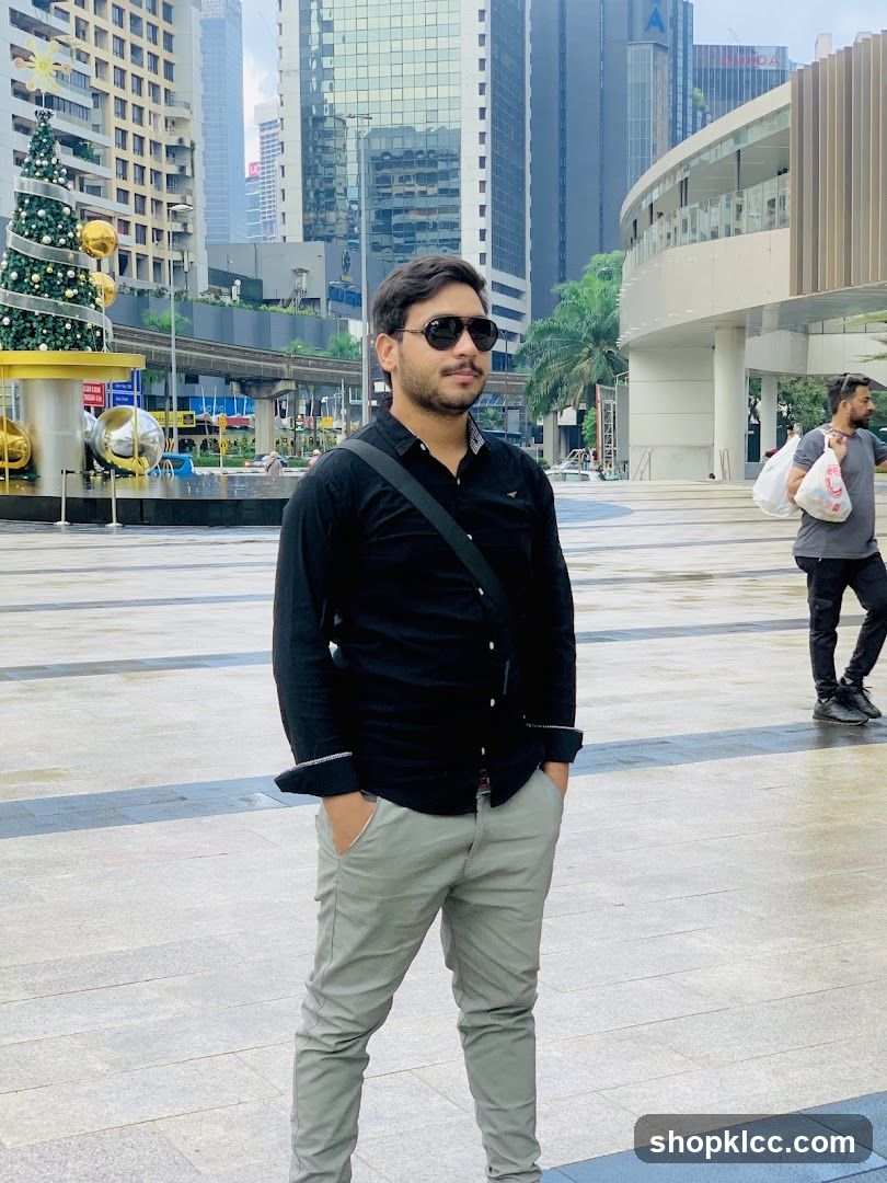 Man posing in a city square