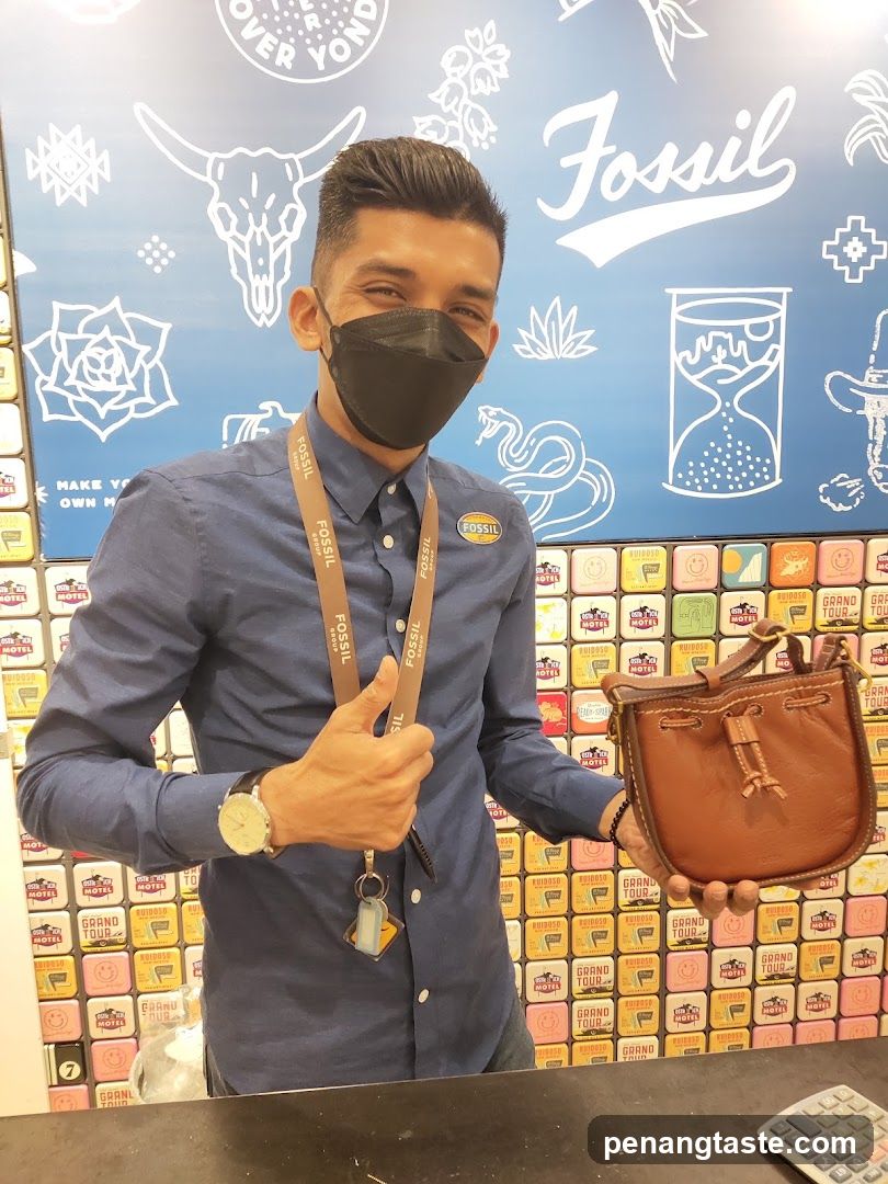 Sales associate holding a Fossil bag