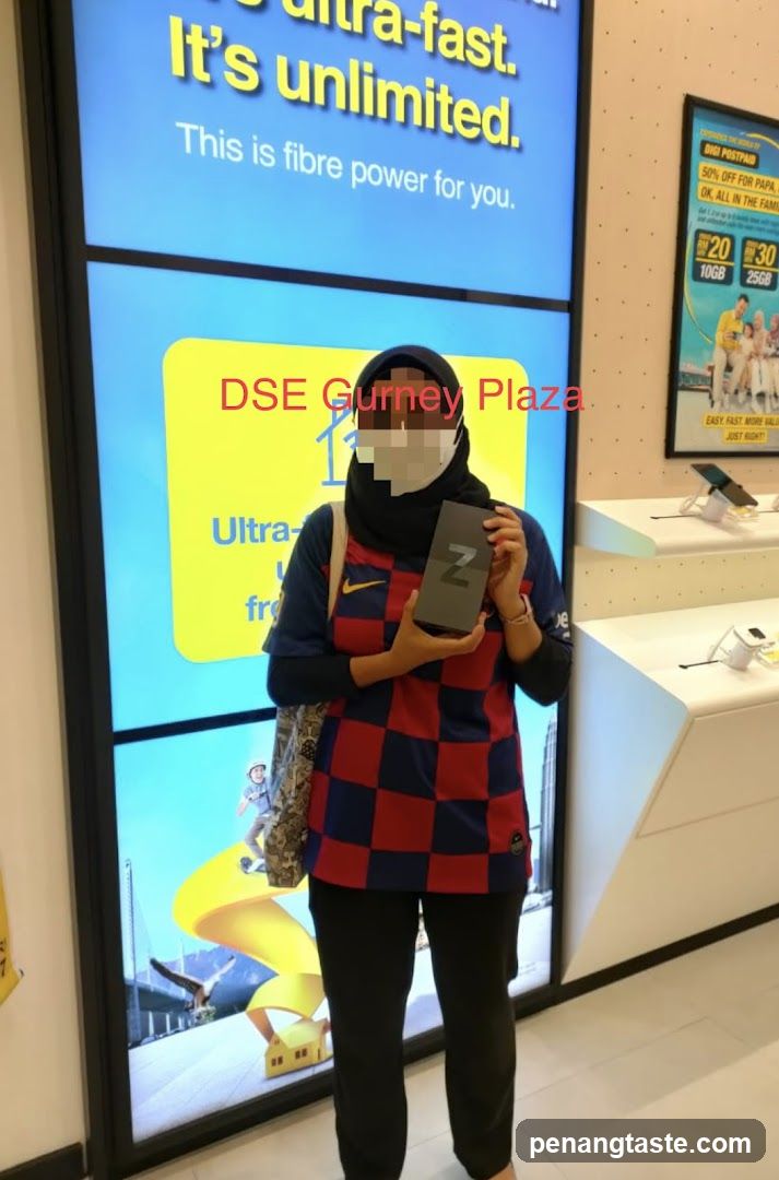 Person holding a phone box in a store