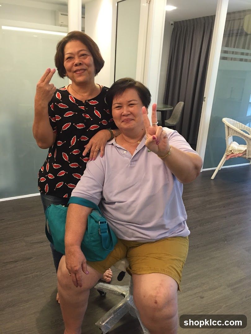 Two women posing indoors with peace signs