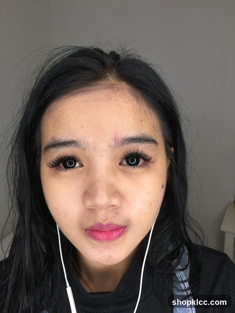 Portrait of a person with makeup and earphones
