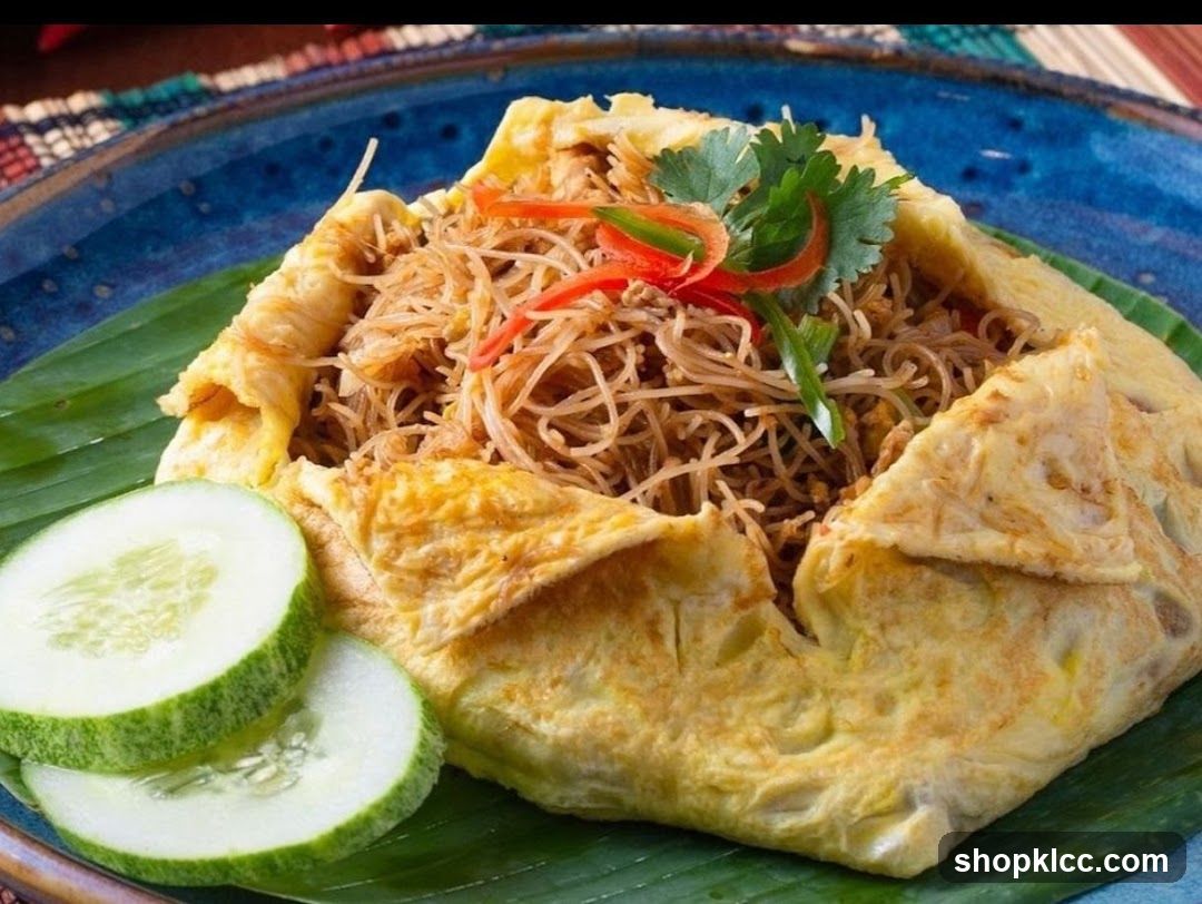 Egg-wrapped noodles with cucumber garnish