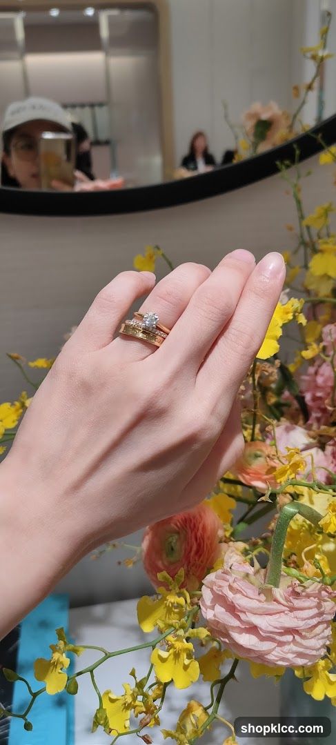 Diamond ring on hand with flowers