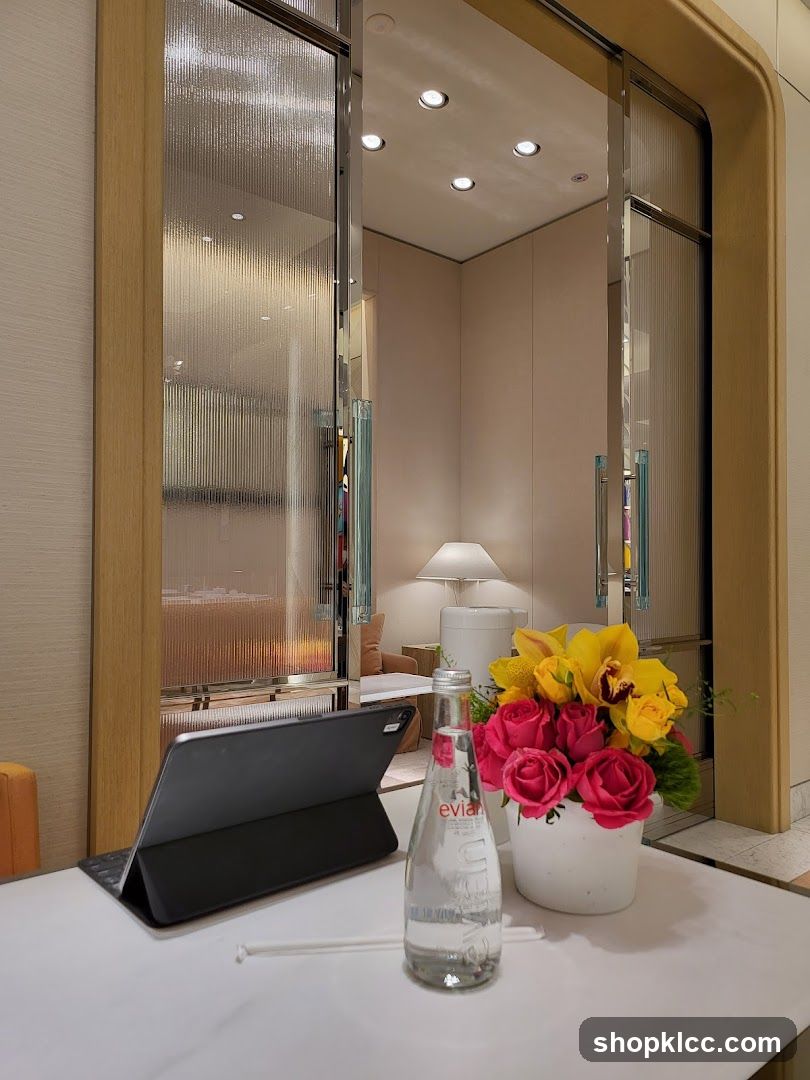 Tabletop with Tablet, Water, and Flowers