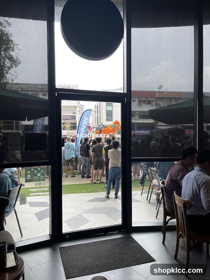 People watching a dragon dance performance outside a Starbucks