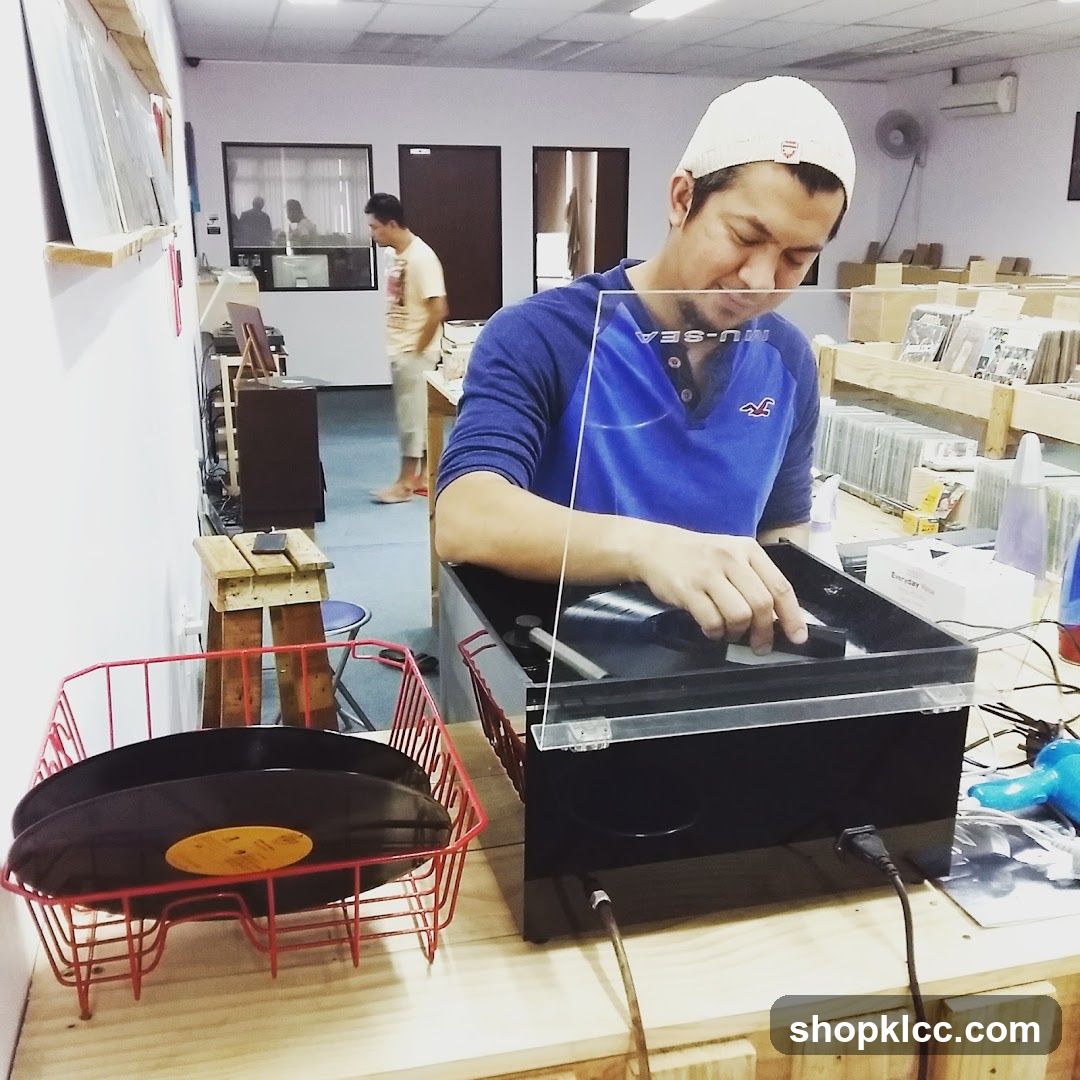 Man cleaning a vinyl record