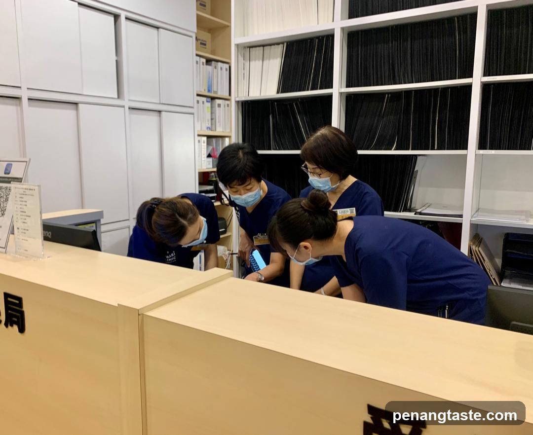 Staff gathered around a phone at a reception desk