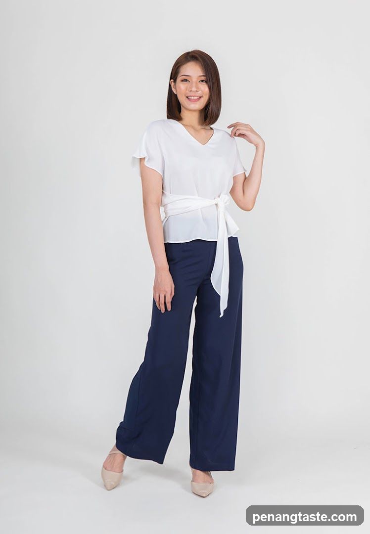 Woman in white top and navy pants
