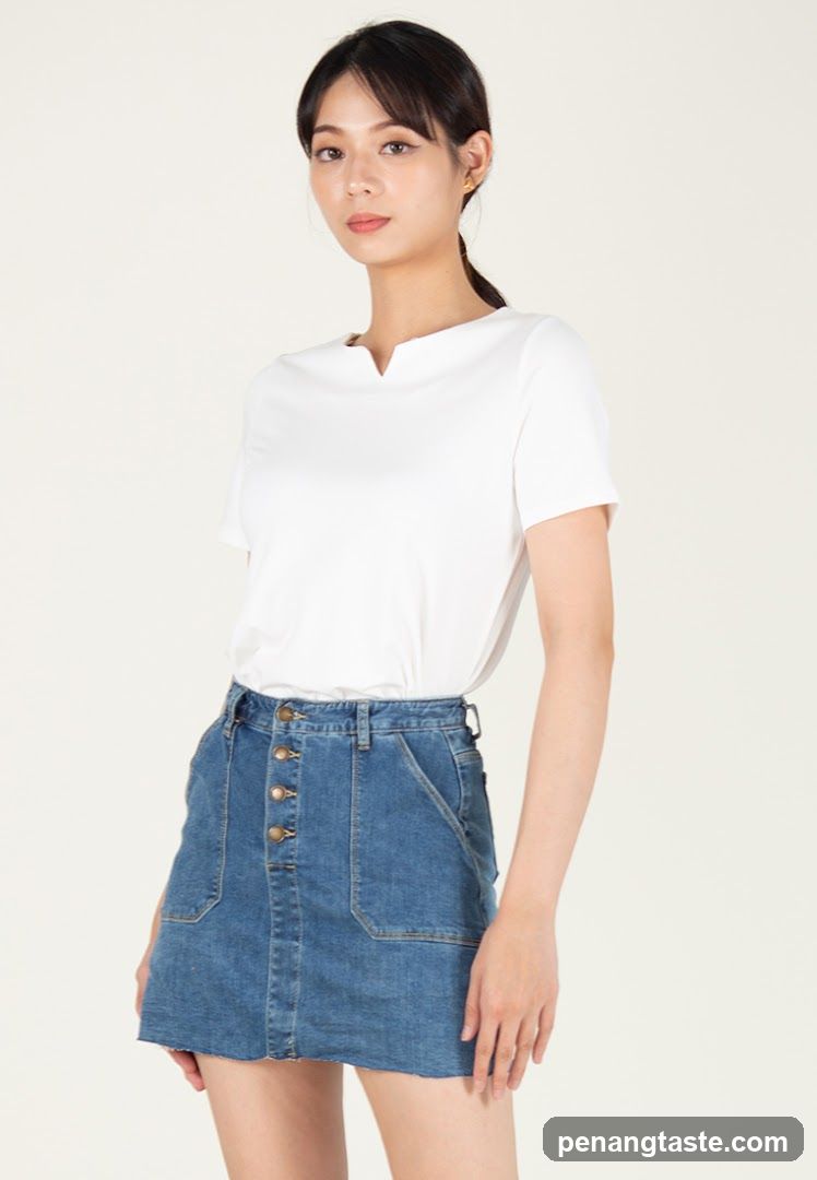 Woman in white top and denim skirt