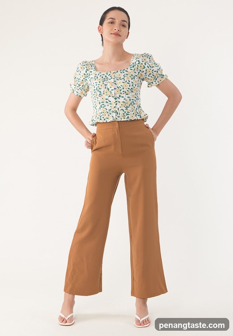 Woman in floral top and brown pants