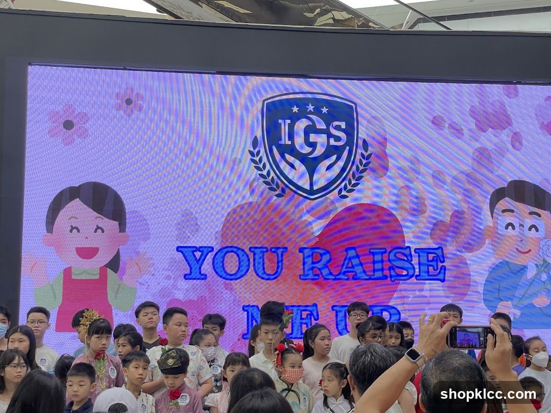 Children and a large screen with a logo and text