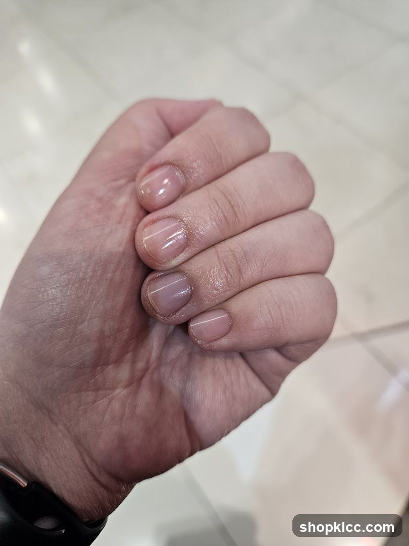 Close-up of a hand with light pink polished nails