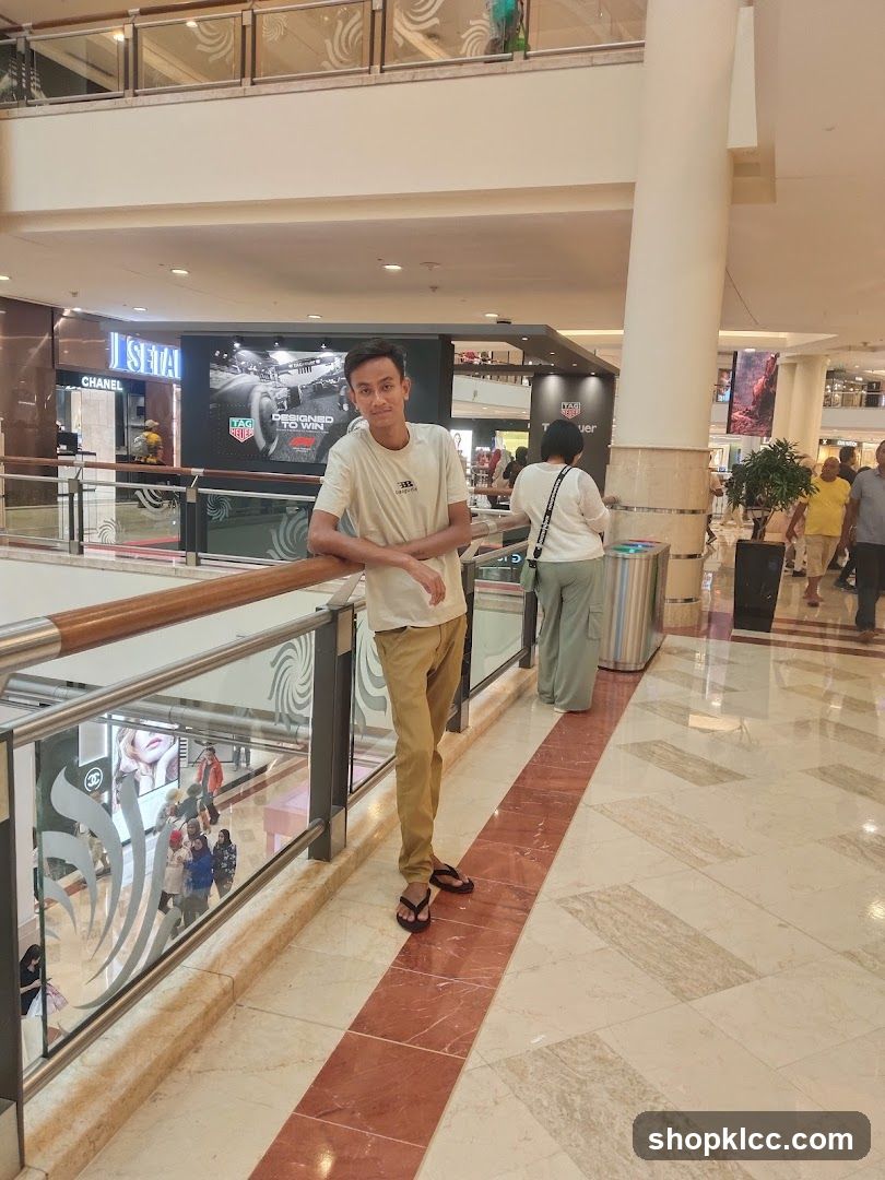 Man leaning on railing in mall