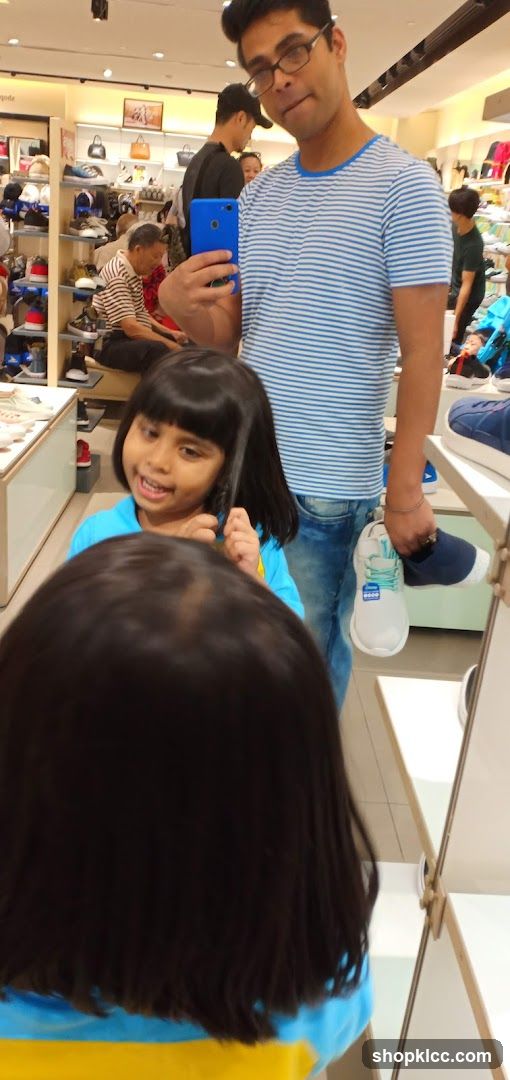 Man and children in a shoe store
