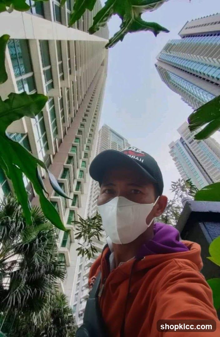 Man in face mask and cap with skyscrapers in background
