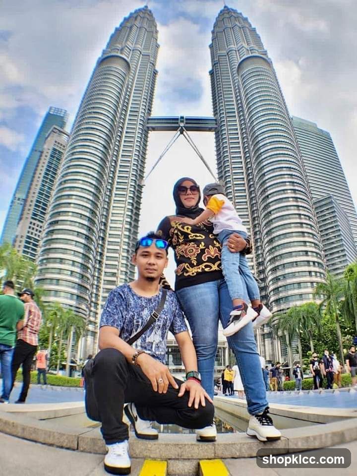 Family posing in front of Petronas Towers
