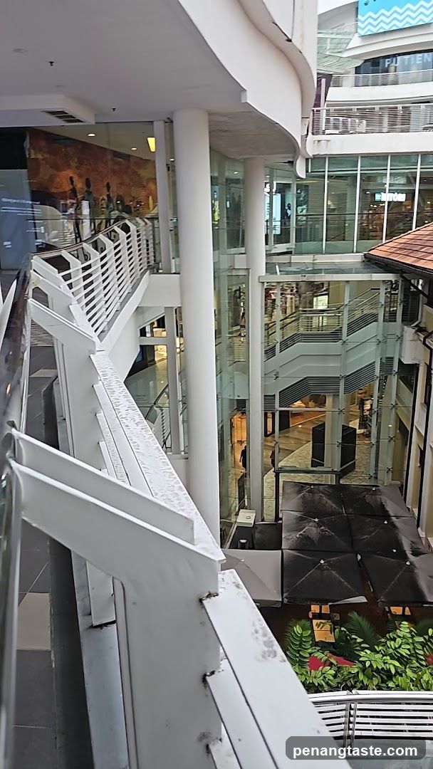 Indoor mall atrium with escalators and shops