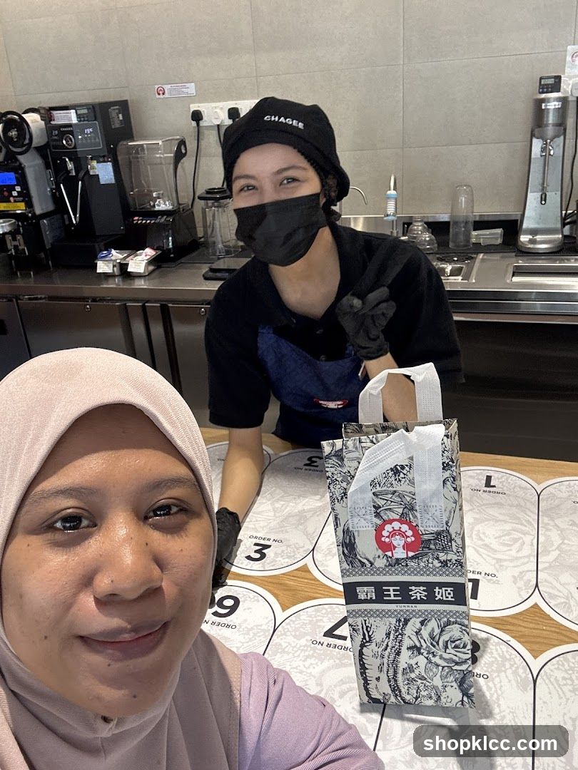 Customer and Staff at a Beverage Shop