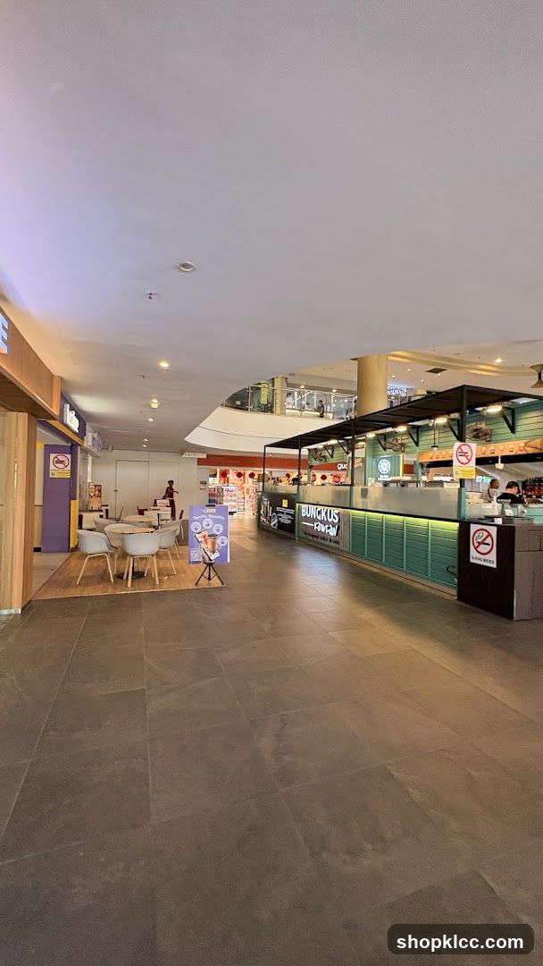 Indoor mall food court with seating areas and food stalls